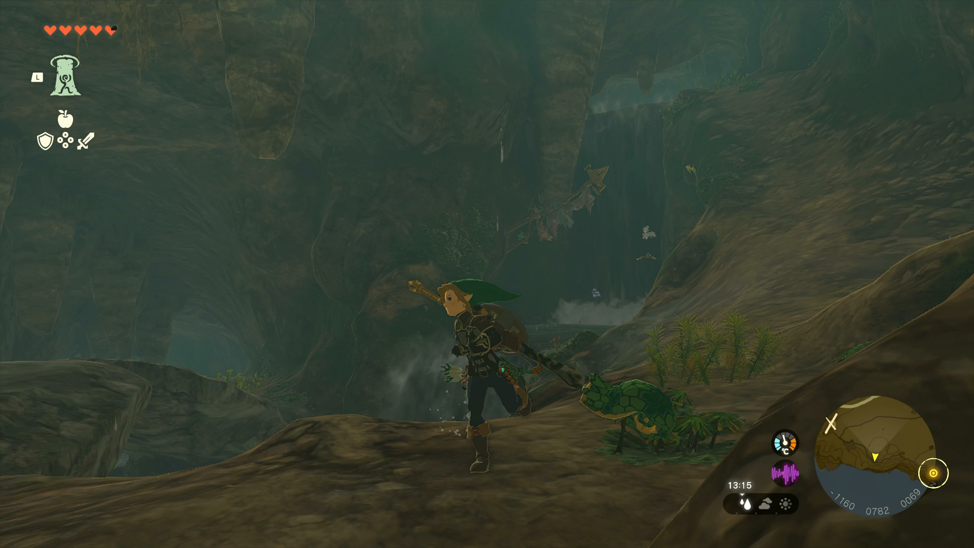 Link searching behind a waterfall for Misko&rsquo;s Treasure in Zelda: Tears of the Kingdom