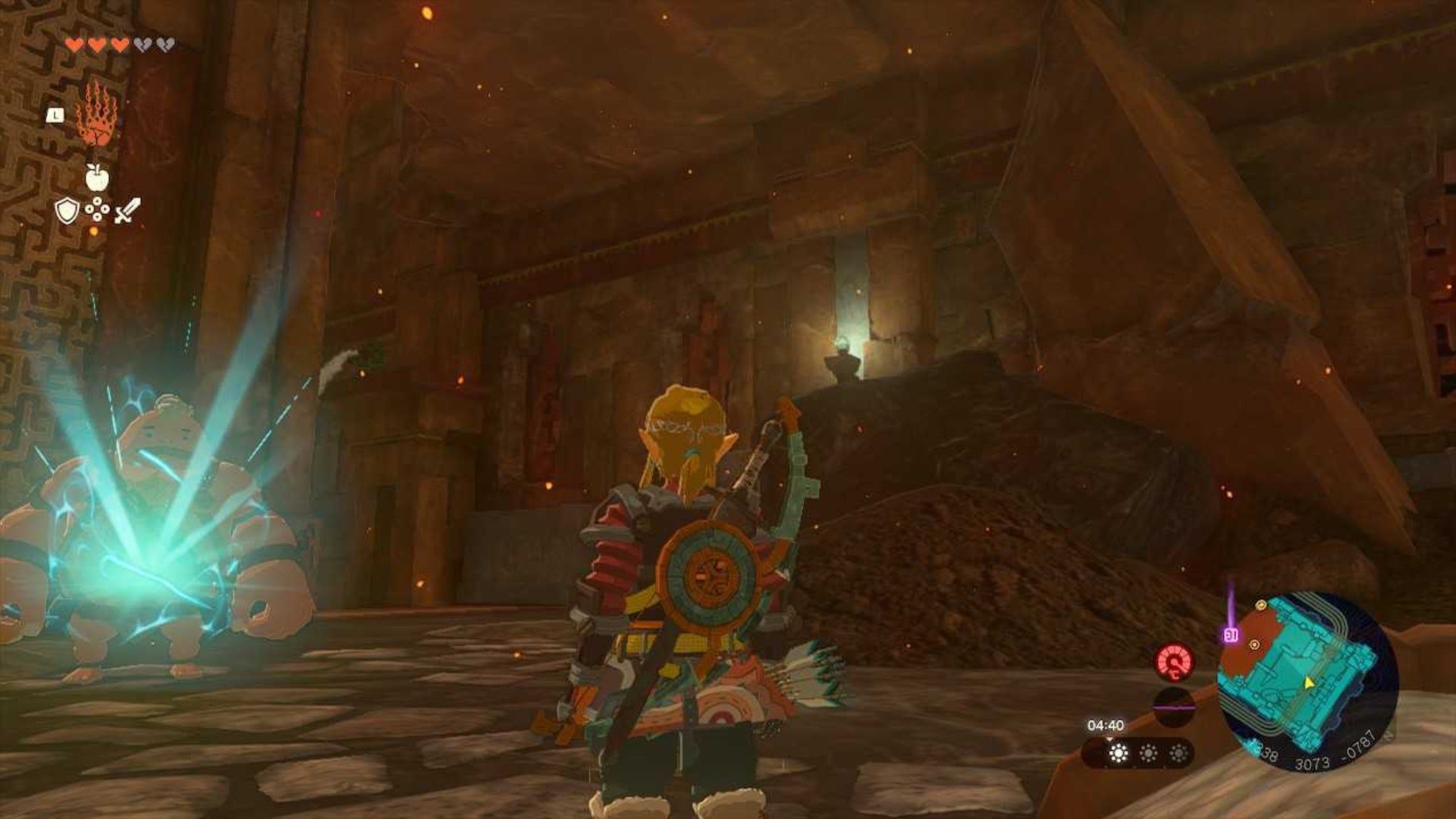 Zelda TOTK, Link is standing in front of a gong in the Fire Temple looking at a slanted stone pillar.