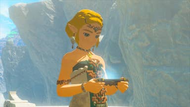 Screenshot of Tears of the Kingdom showing blonde-haired Zelda holding a tablet device