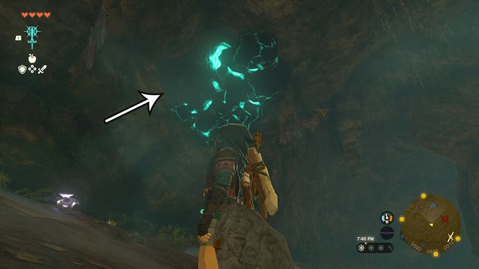 An arrow pointing at rocks players need to destroy in the Crenel Hills Cave so Link can find the Barbarian Armor.