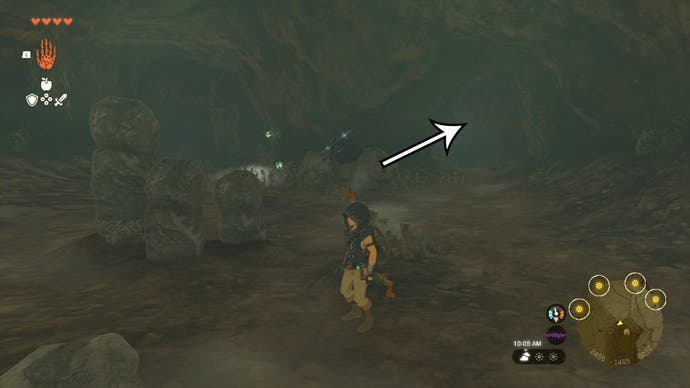 Link in the Robred Dropoff Cave, with an arrow pointing in the direction players need to head to find the Barbarian Helm.