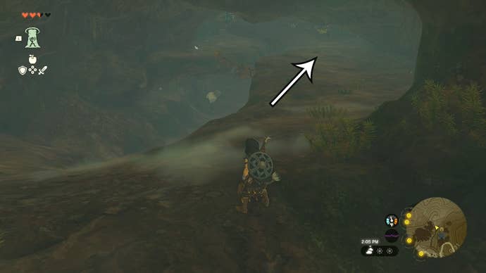 Link in the Walnot Mountain Cave with an arrow pointing in the direction players need to head to find the Barbarian Leg Wraps.