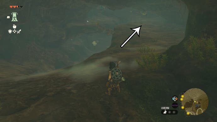 Link in the Walnot Mountain Cave with an arrow pointing in the direction players need to head to find the Barbarian Leg Wraps.